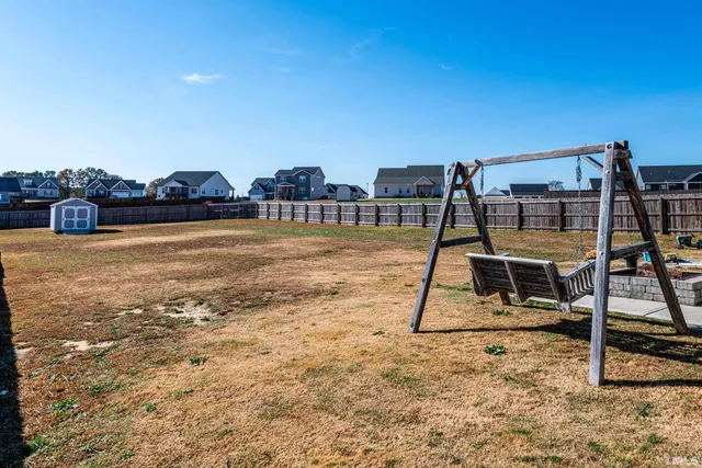 a view of a street with a house in the background