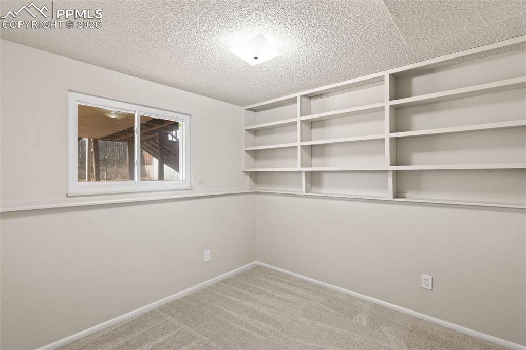 1620 Winnebago Road Colorado Springs, CO 80915 - Photo 18 of 25 a view of an empty room with a window