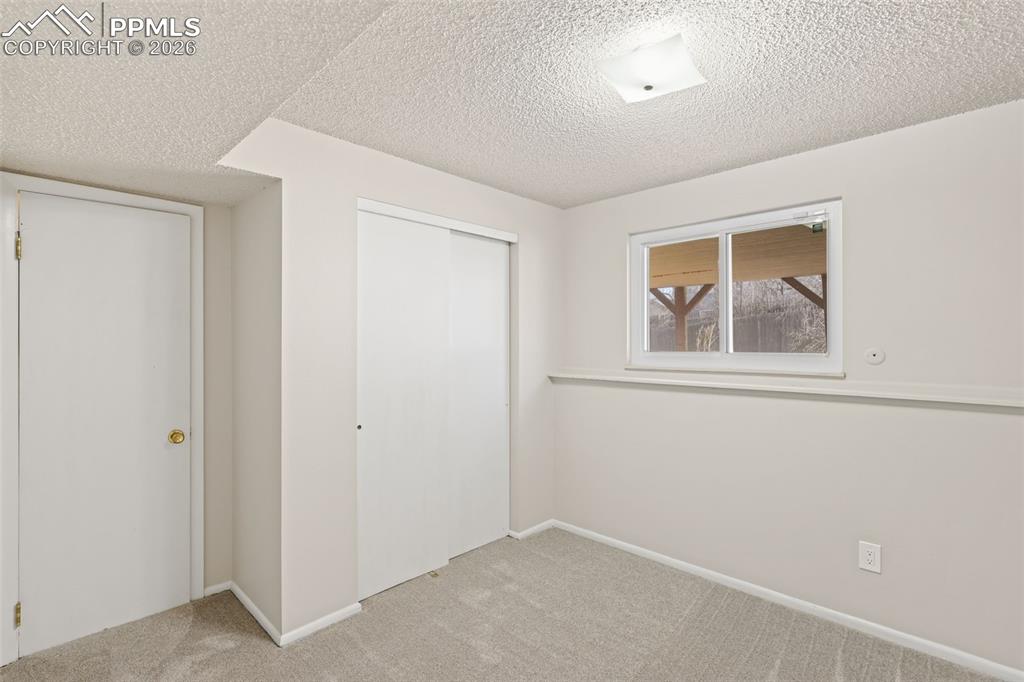 1620 Winnebago Road Colorado Springs, CO 80915 - Photo 19 of 25 an empty room with windows