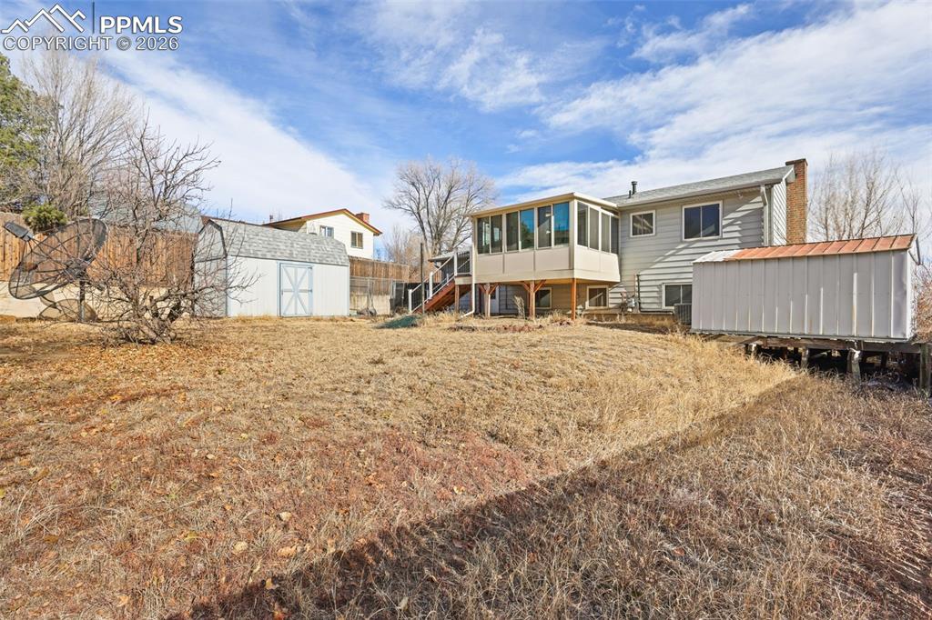 1620 Winnebago Road Colorado Springs, CO 80915 - Photo 22 of 25 a view of a house with a yard covered in snow