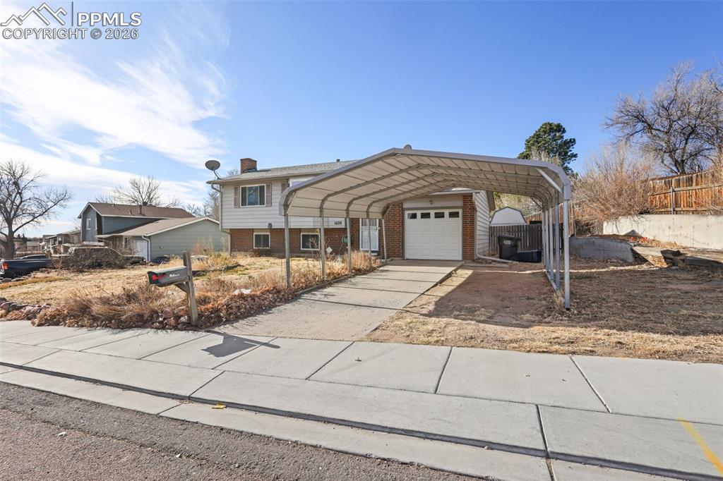 1620 Winnebago Road Colorado Springs, CO 80915 - Photo 24 of 25 a front view of a house with a yard