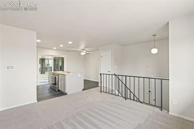 a view of a hallway with wooden floor and windows