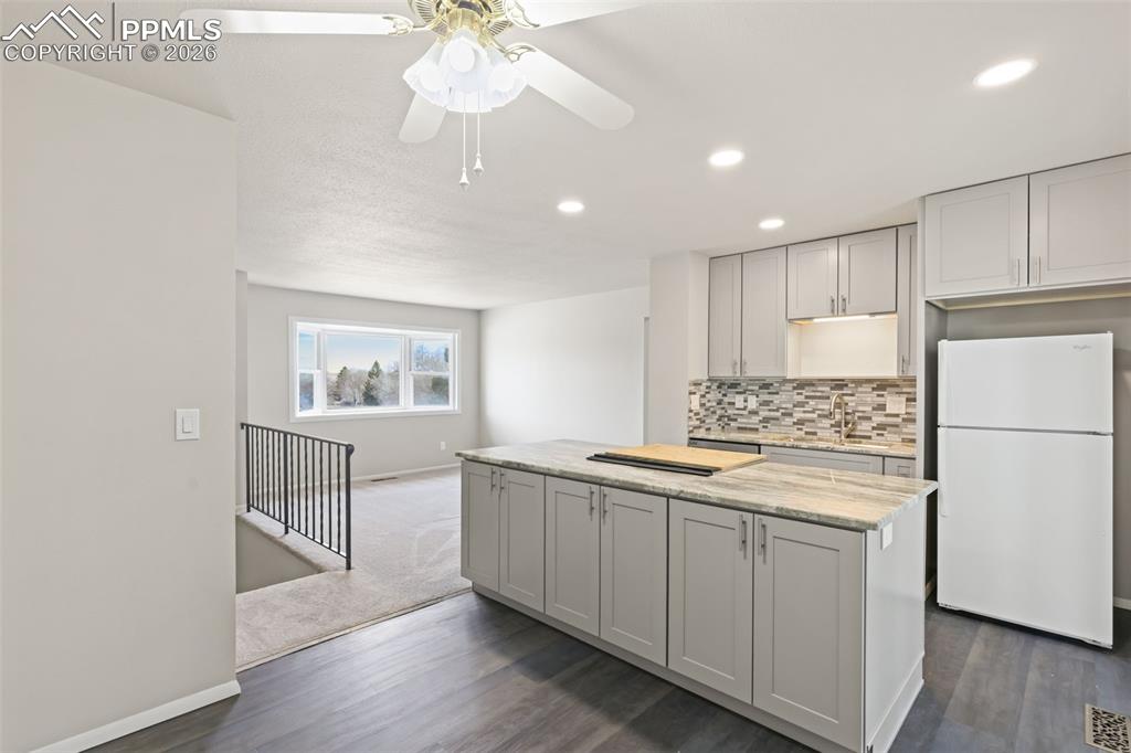 1620 Winnebago Road Colorado Springs, CO 80915 - Photo 8 of 25 a kitchen with a sink stainless steel appliances and cabinets