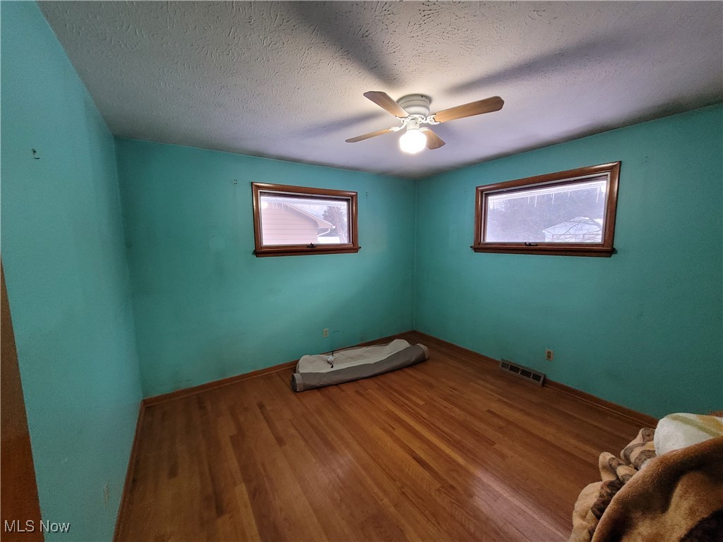 14855 Drake Road Strongsville, OH 44136 - Photo 13 of 15 Bedroom with hardwood floors, a textured ceiling, and ceiling fan