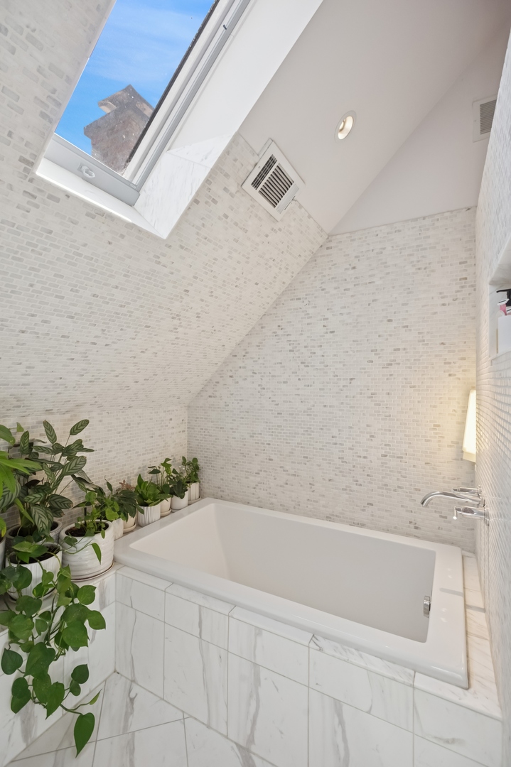 832 West Wolfram Street Chicago, IL 60657 - Photo 39 of 51 a bathroom with a bathtub and shower