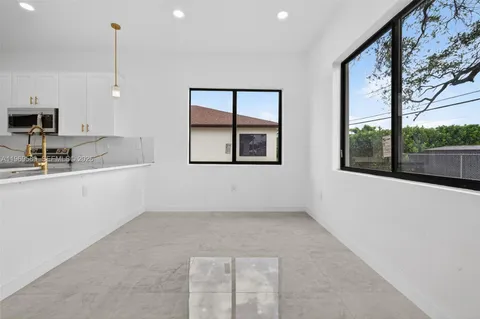 a kitchen with windows and sink