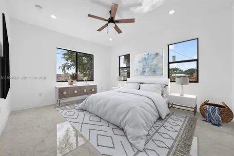 a bedroom with a large bed and a flat screen tv