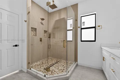 a bathroom with a shower and a sink