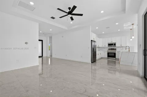 a view of kitchen with refrigerator and microwave