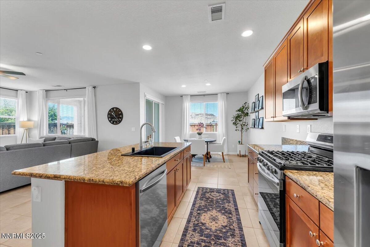 2642 Alessandro Court Sparks, NV 89434 - Photo 17 of 52 a kitchen with granite countertop sink stove and cabinets