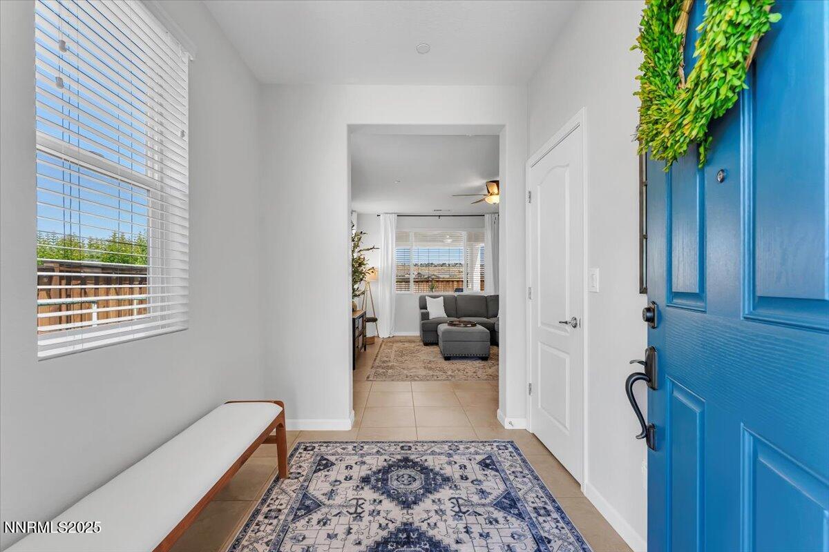 2642 Alessandro Court Sparks, NV 89434 - Photo 9 of 52 a hallway with a couch and a potted plant