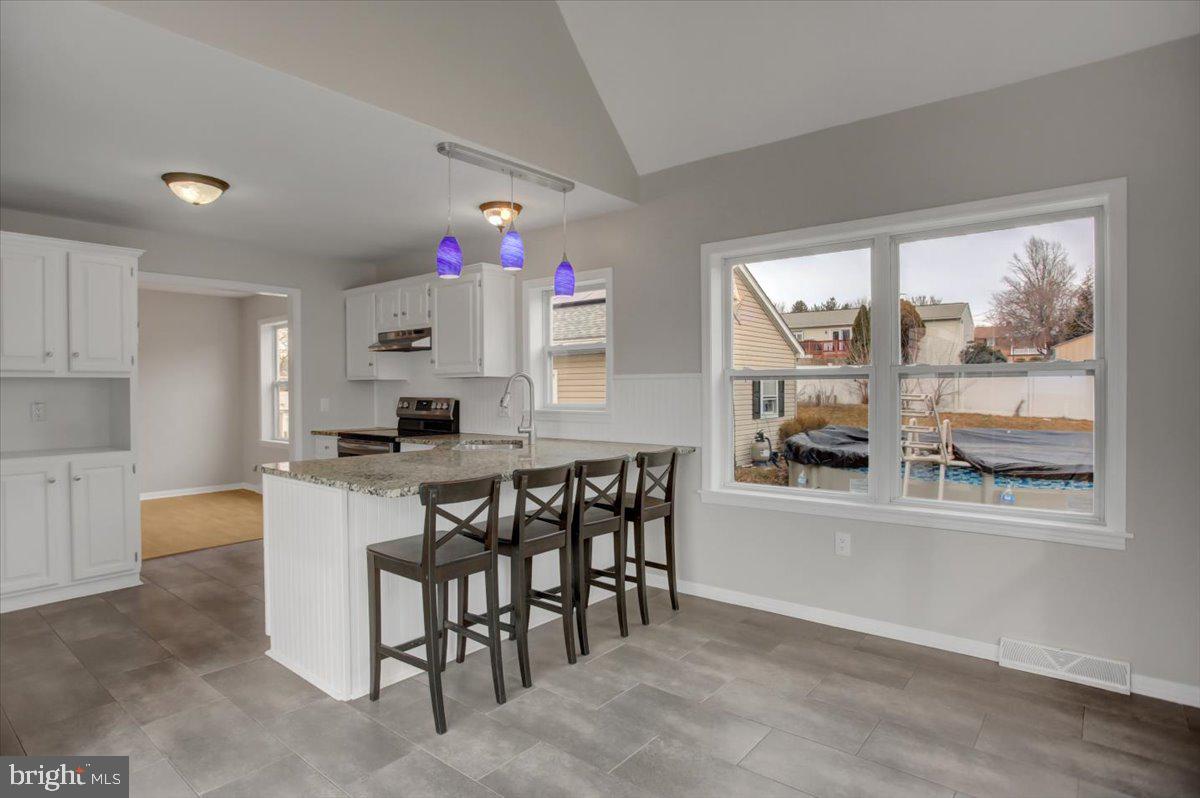 124 West Hunter Road Carlisle, PA 17015 - Photo 14 of 36 a kitchen with a wooden floor and white cabinets