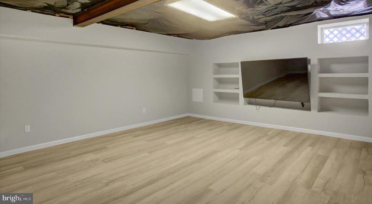 124 West Hunter Road Carlisle, PA 17015 - Photo 32 of 36 an empty room with wooden floor and fan