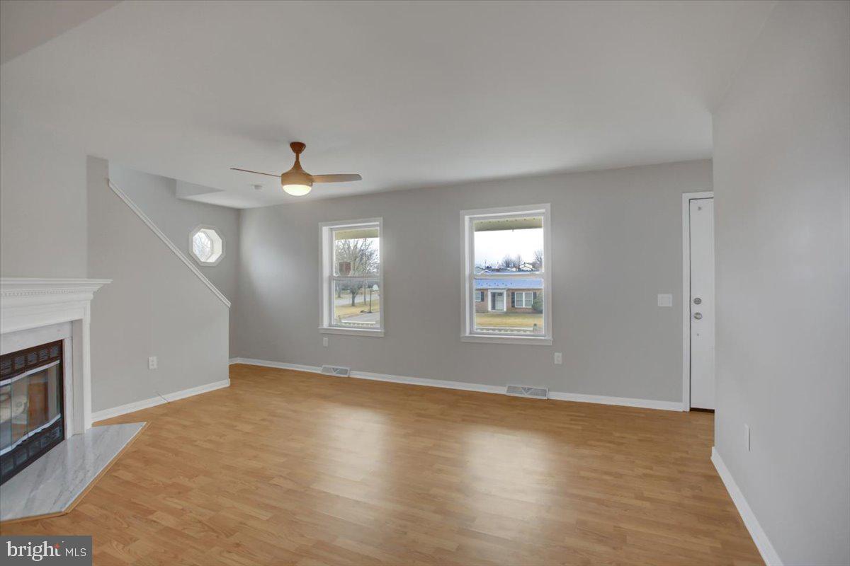 124 West Hunter Road Carlisle, PA 17015 - Photo 7 of 36 an empty room with windows and fireplace