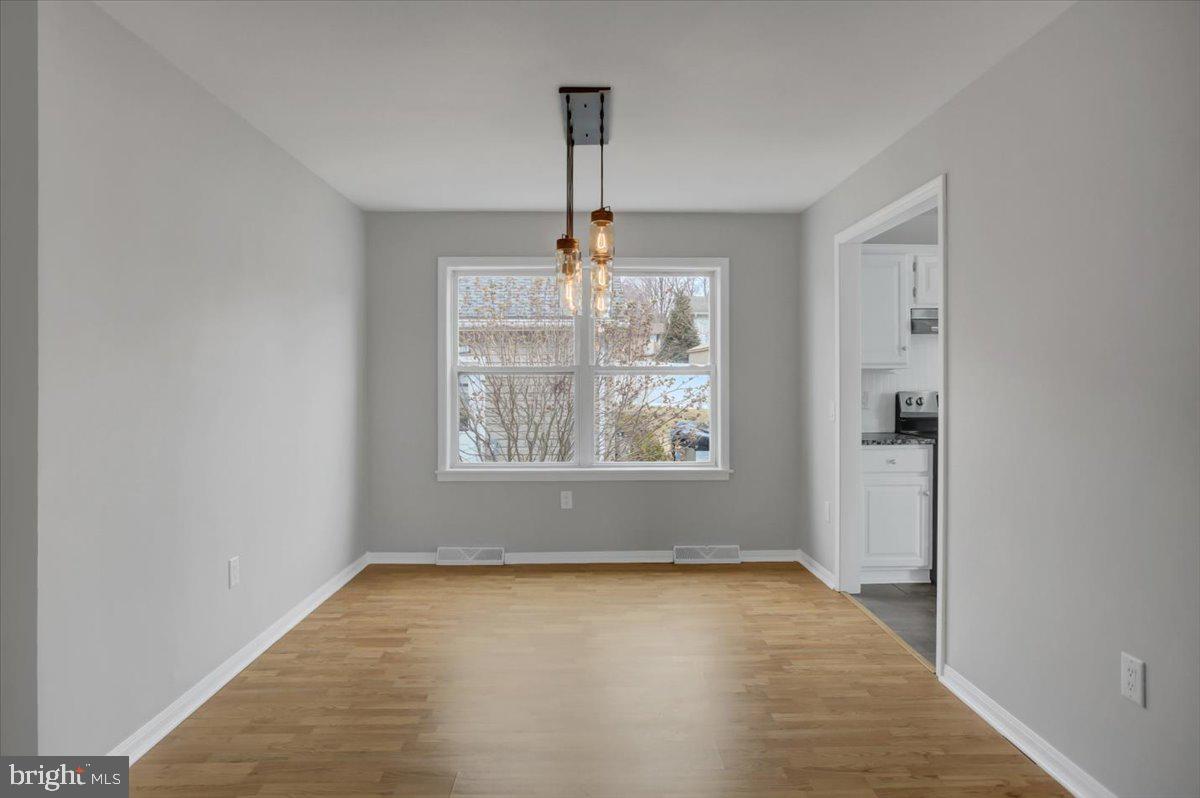 124 West Hunter Road Carlisle, PA 17015 - Photo 8 of 36 an empty room with windows and chandelier fan