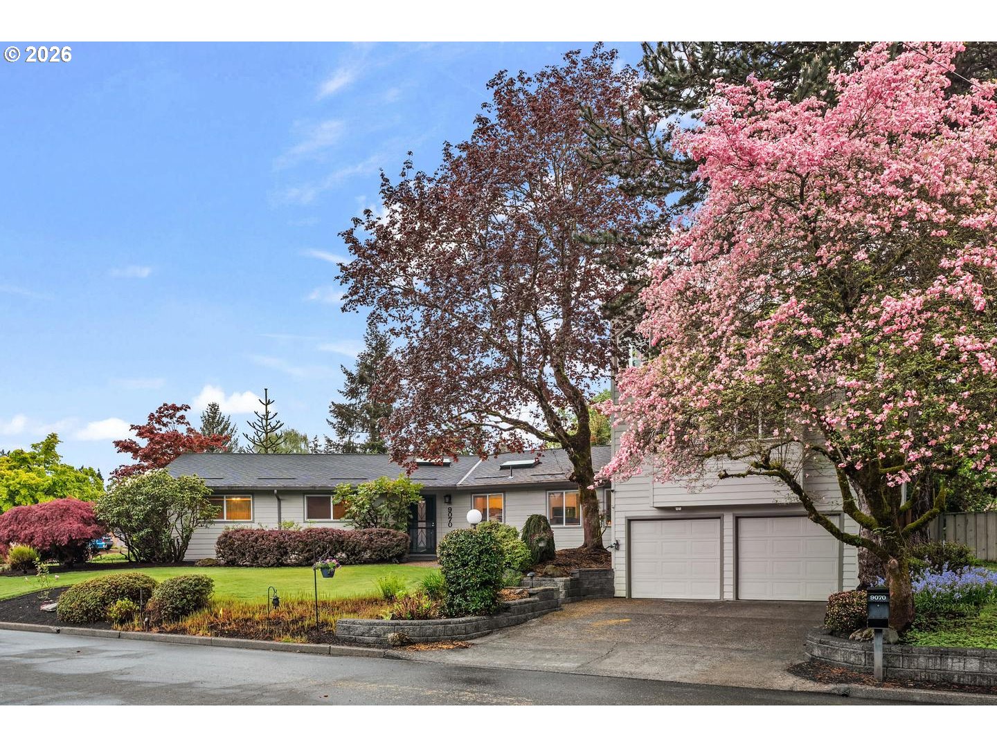 9070 Southwest Howatt Street Portland, OR 97225 - Photo 2 of 48 a front view of a house with a garden and tree