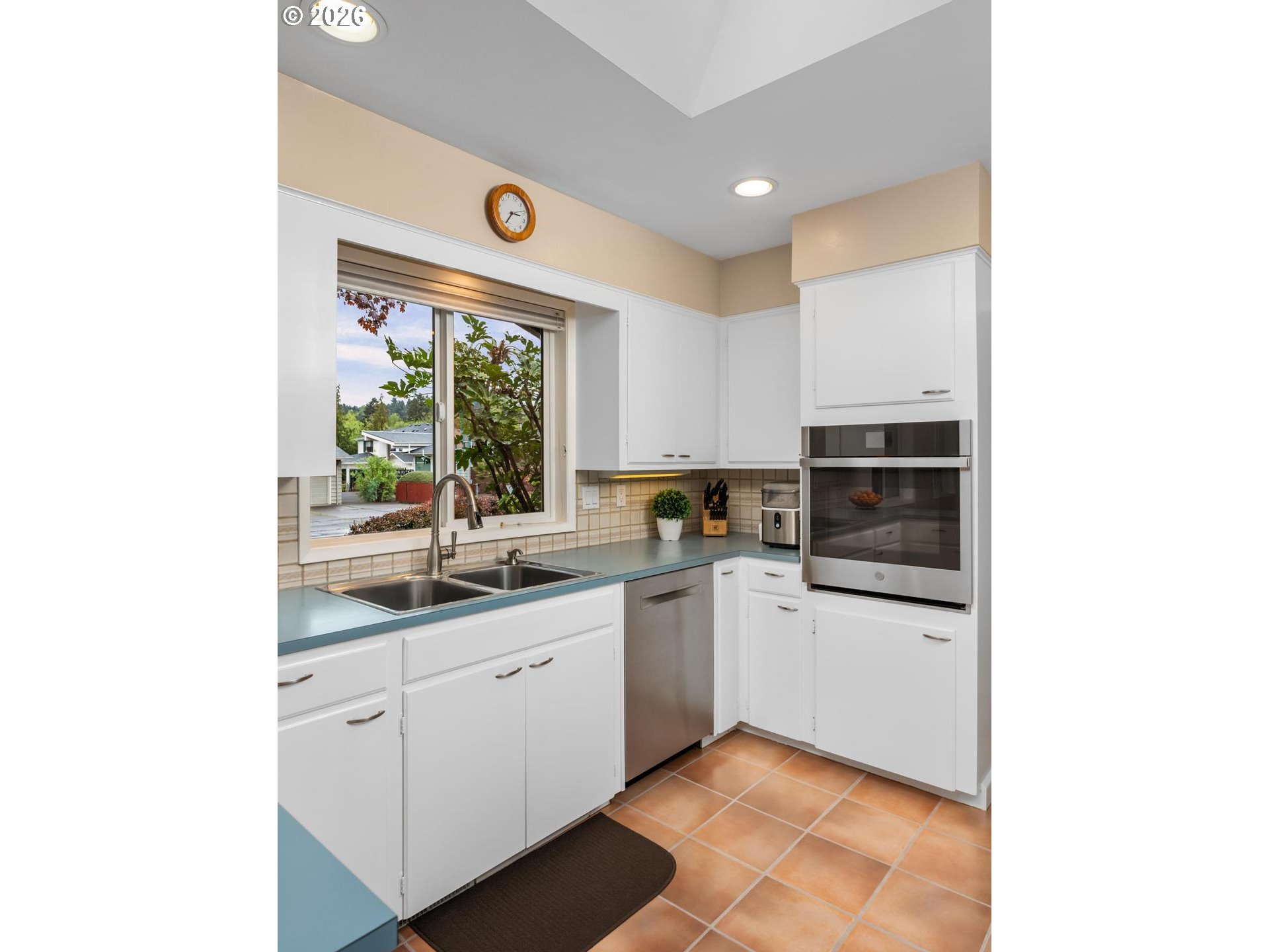 9070 Southwest Howatt Street Portland, OR 97225 - Photo 21 of 48 a kitchen with a sink cabinets and window