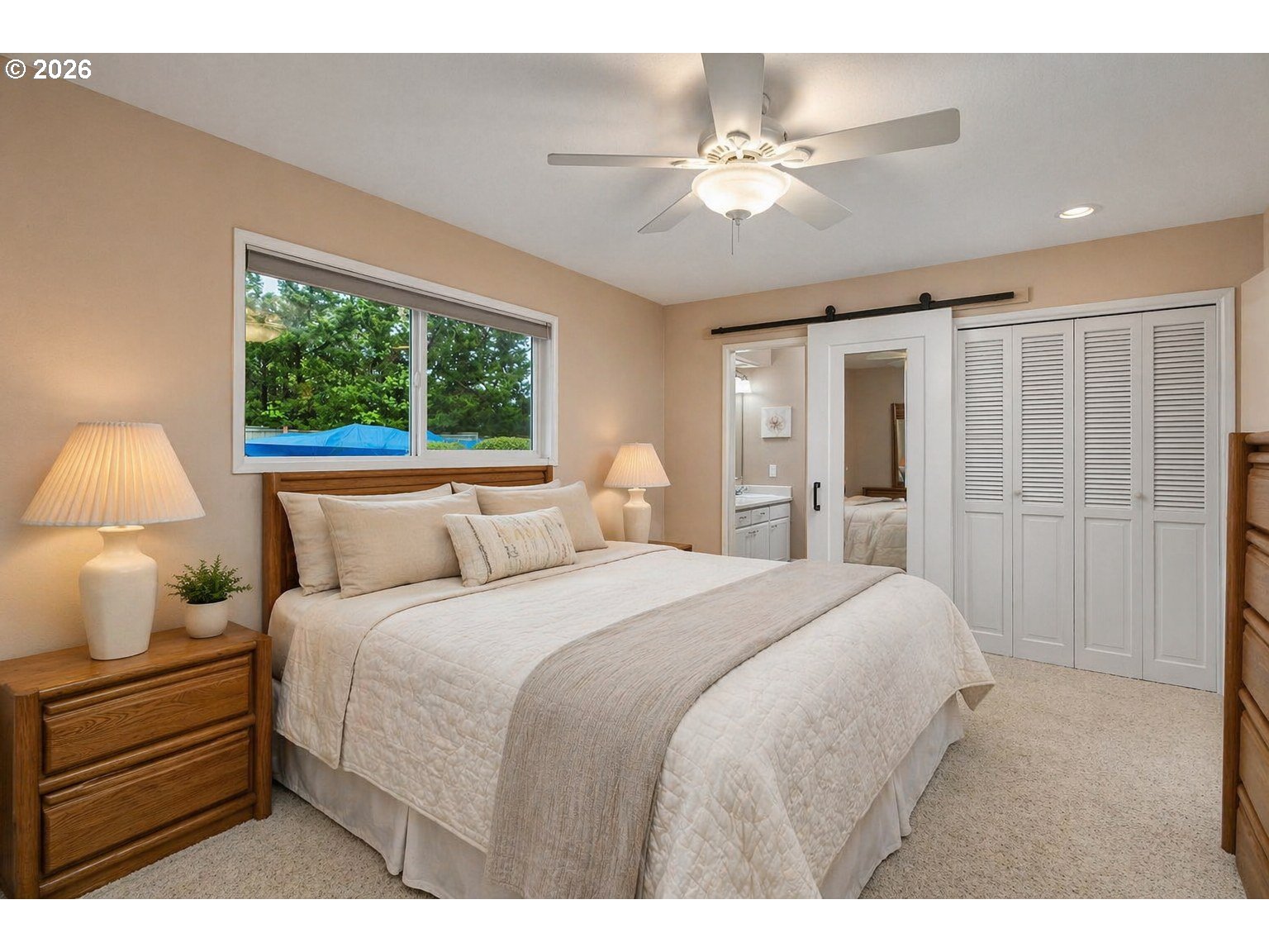 9070 Southwest Howatt Street Portland, OR 97225 - Photo 22 of 48 a bedroom with a bed and a chandelier