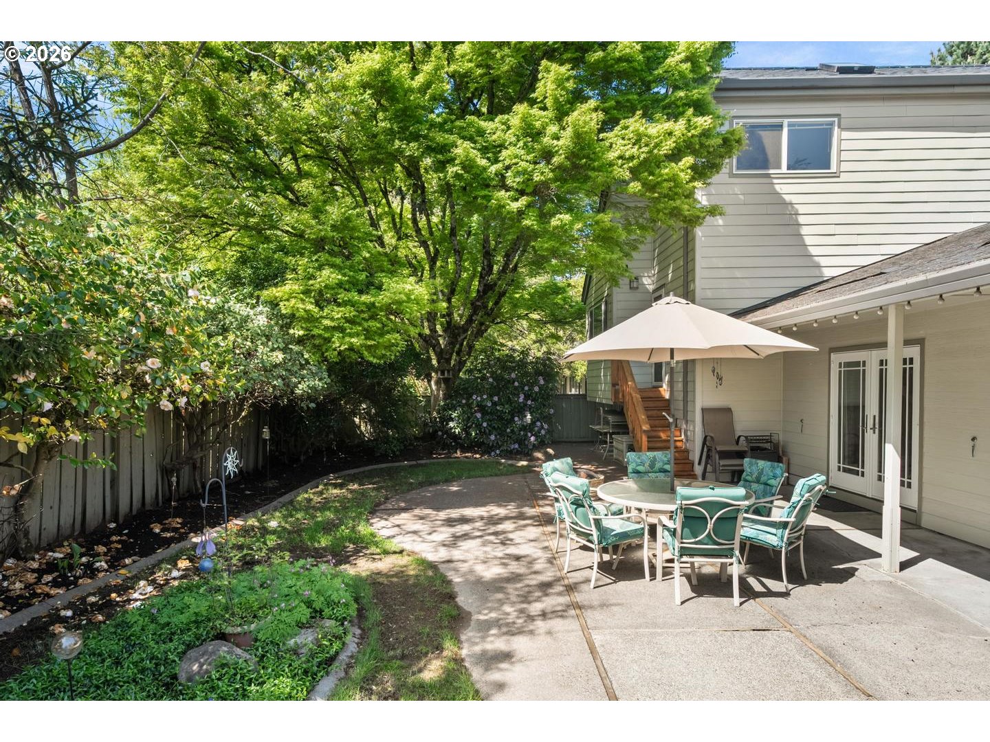 9070 Southwest Howatt Street Portland, OR 97225 - Photo 38 of 48 a view of a patio with table and chairs under an umbrella
