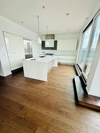 a view of kitchen with microwave a stove a sink and a refrigerator