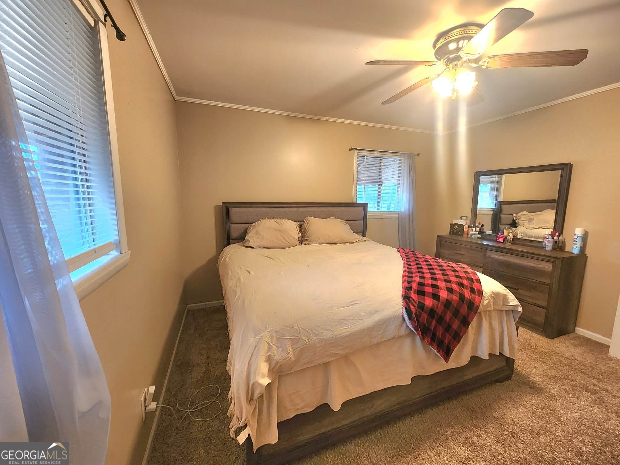 1026 Jackson Road Griffin, GA 30223 - Photo 12 of 21 a bedroom with a bed and dresser with mirror