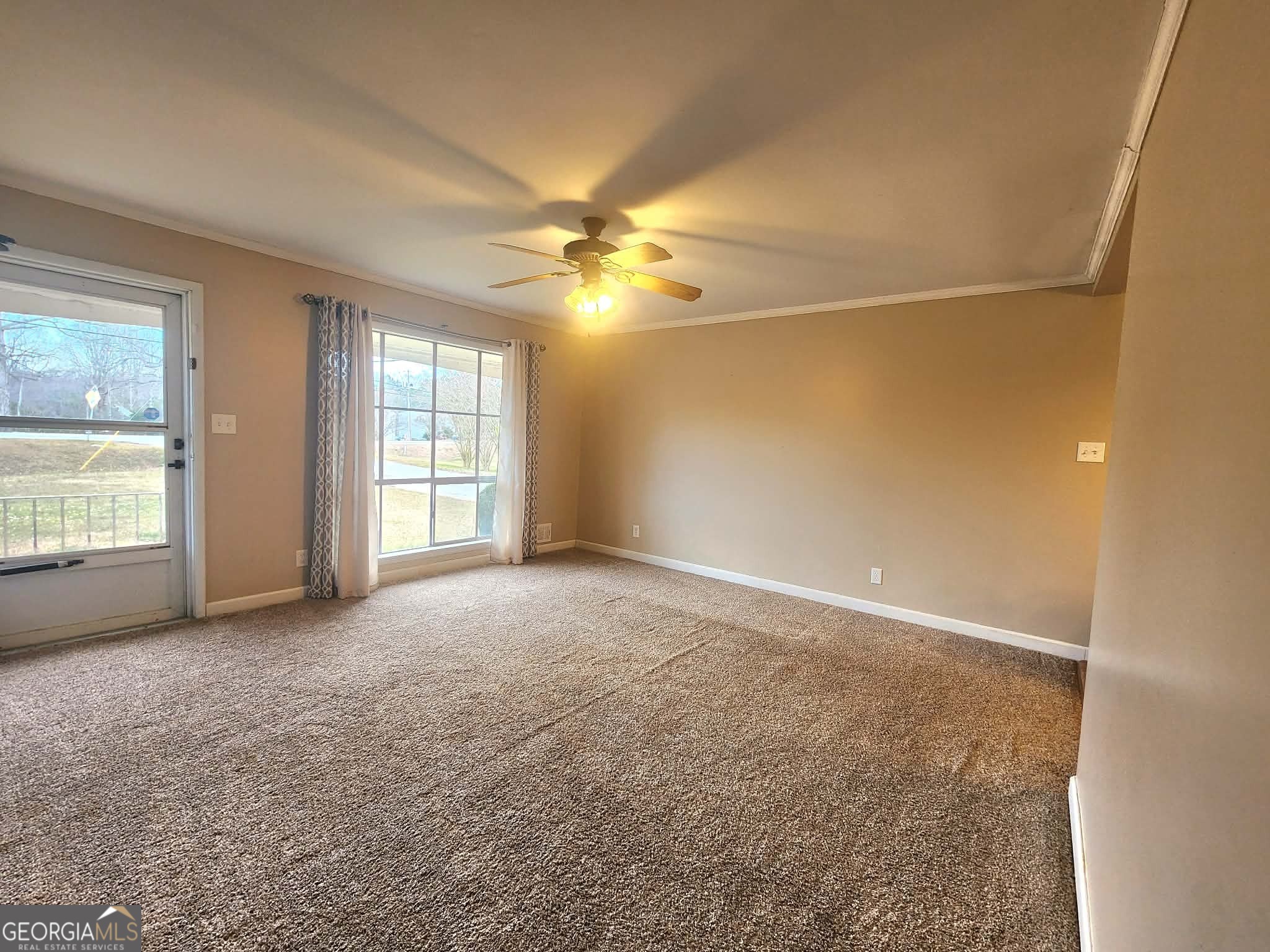 1026 Jackson Road Griffin, GA 30223 - Photo 6 of 21 an empty room with windows and ceiling fan
