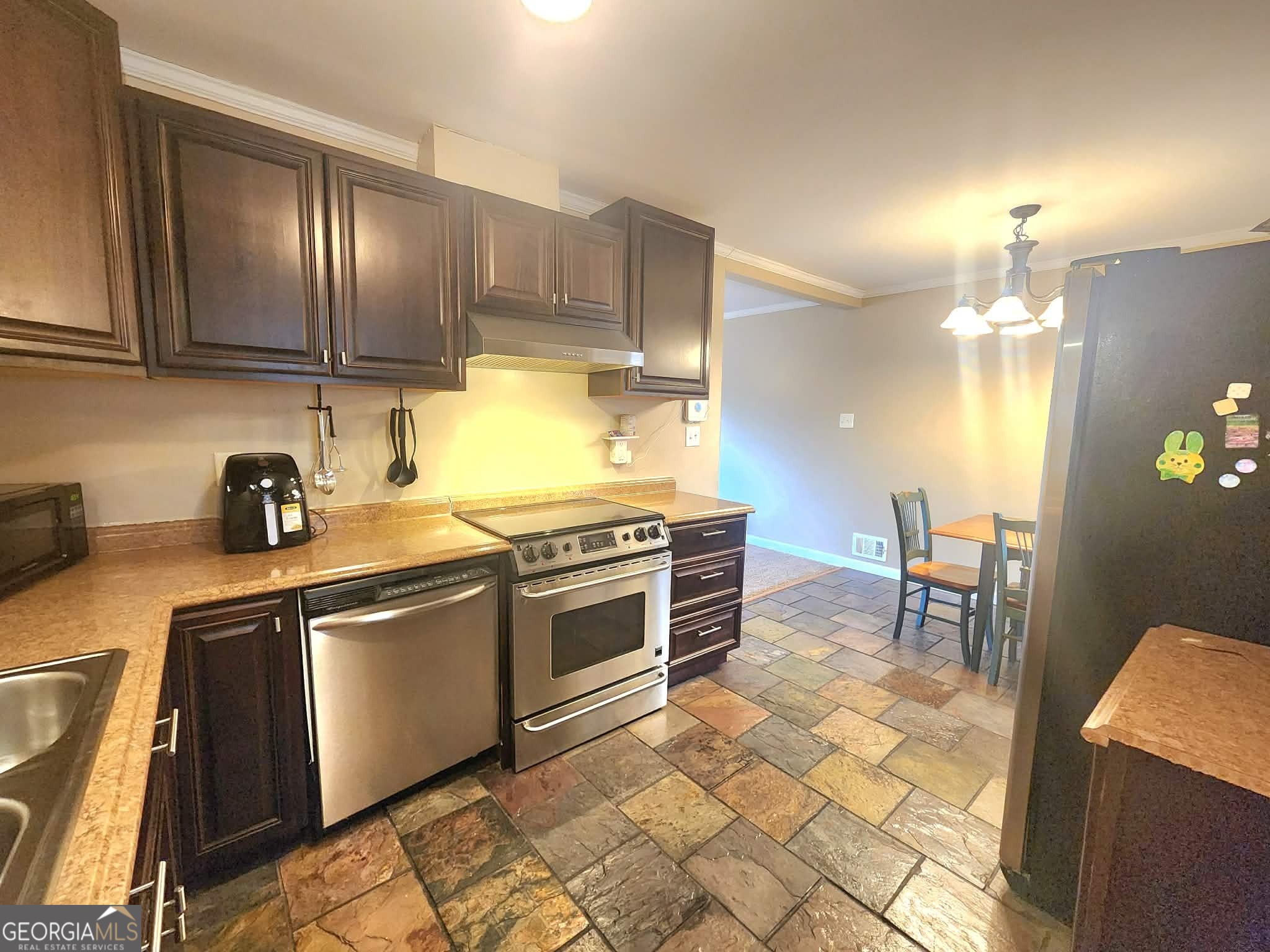 1026 Jackson Road Griffin, GA 30223 - Photo 9 of 21 a kitchen with stainless steel appliances granite countertop a stove a sink and a refrigerator