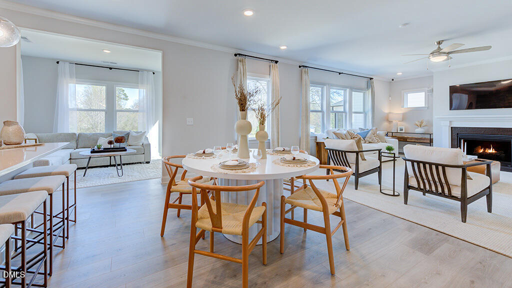 237 Tidal Pool Way Cary, NC 27519 - Photo 13 of 34 a view of a a dining room with furniture window and wooden floor