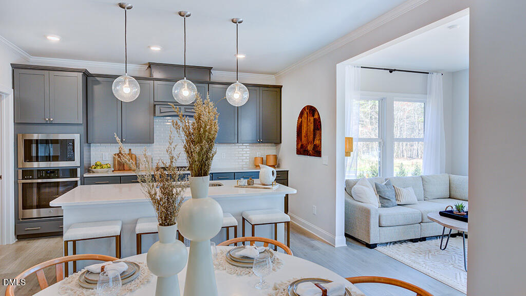 237 Tidal Pool Way Cary, NC 27519 - Photo 15 of 34 a living room with fireplace furniture and a chandelier