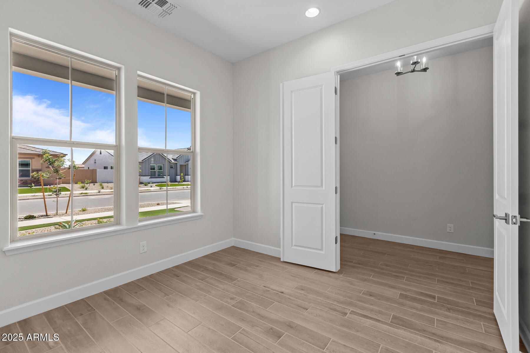 1042 Ridge Road Apache Junction, AZ 85120 - Photo 12 of 27 a view of an empty room with a window and wooden floor