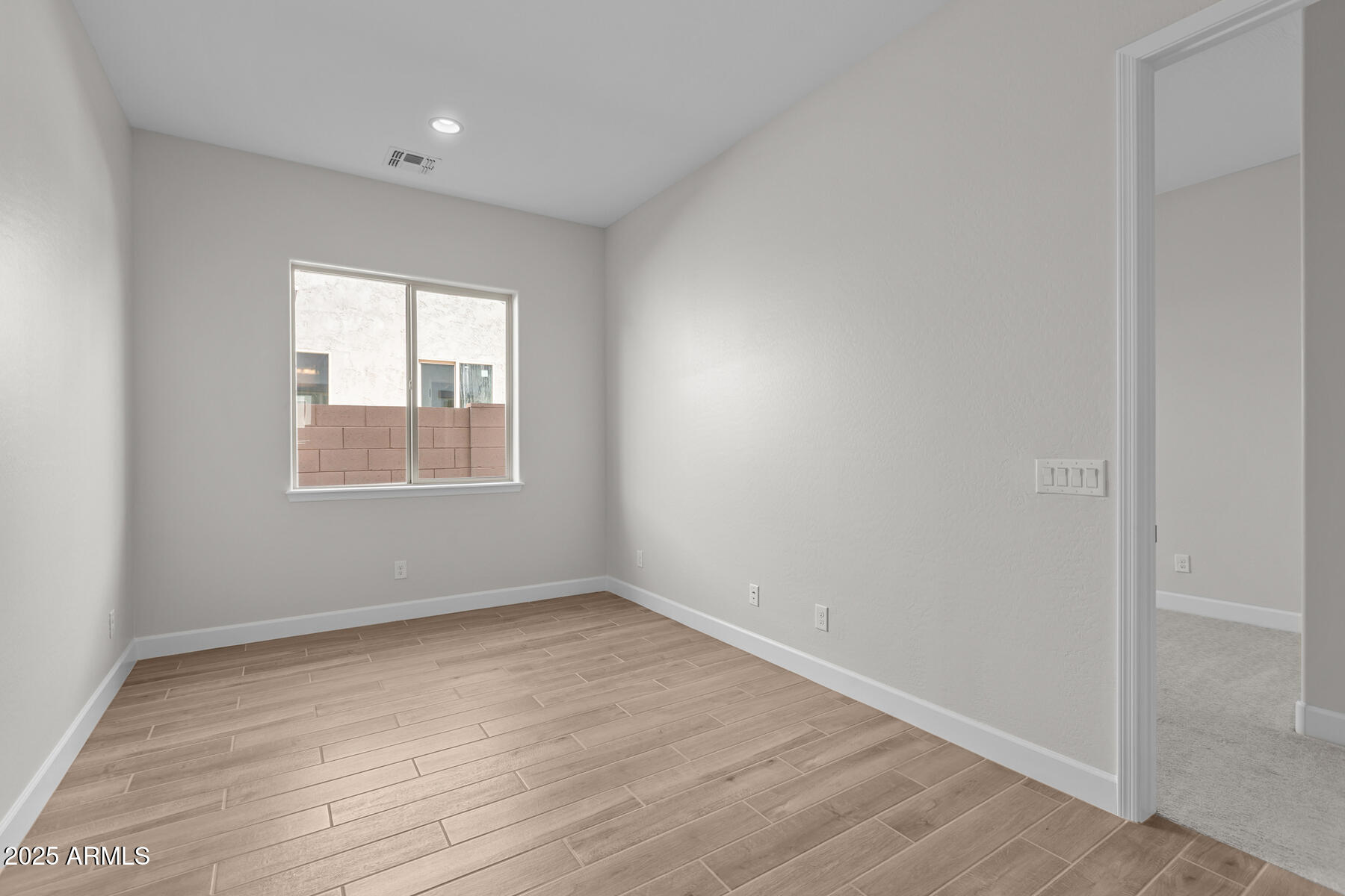 1042 Ridge Road Apache Junction, AZ 85120 - Photo 13 of 27 an empty room with wooden floor and windows