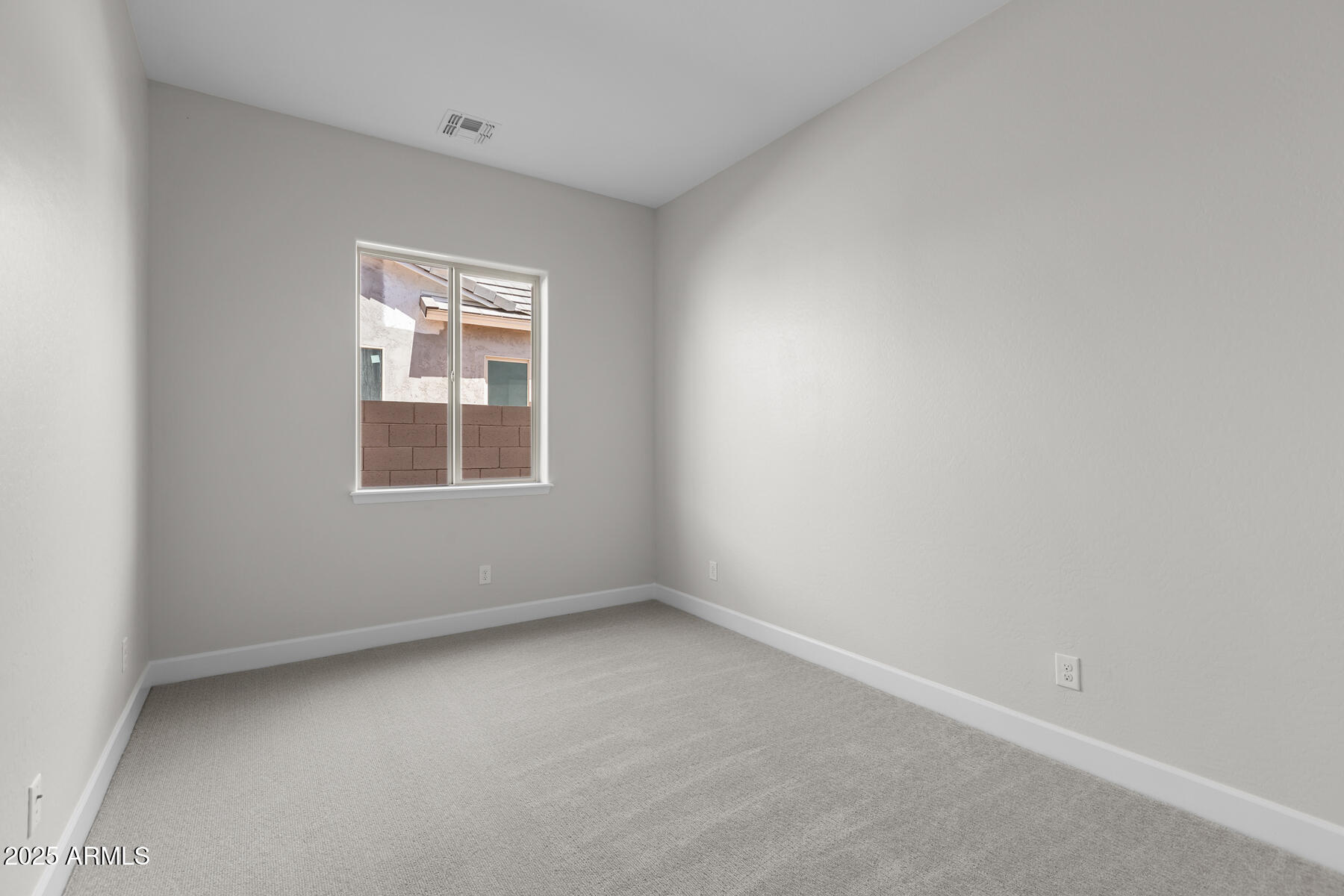 1042 Ridge Road Apache Junction, AZ 85120 - Photo 16 of 27 an empty room with a window