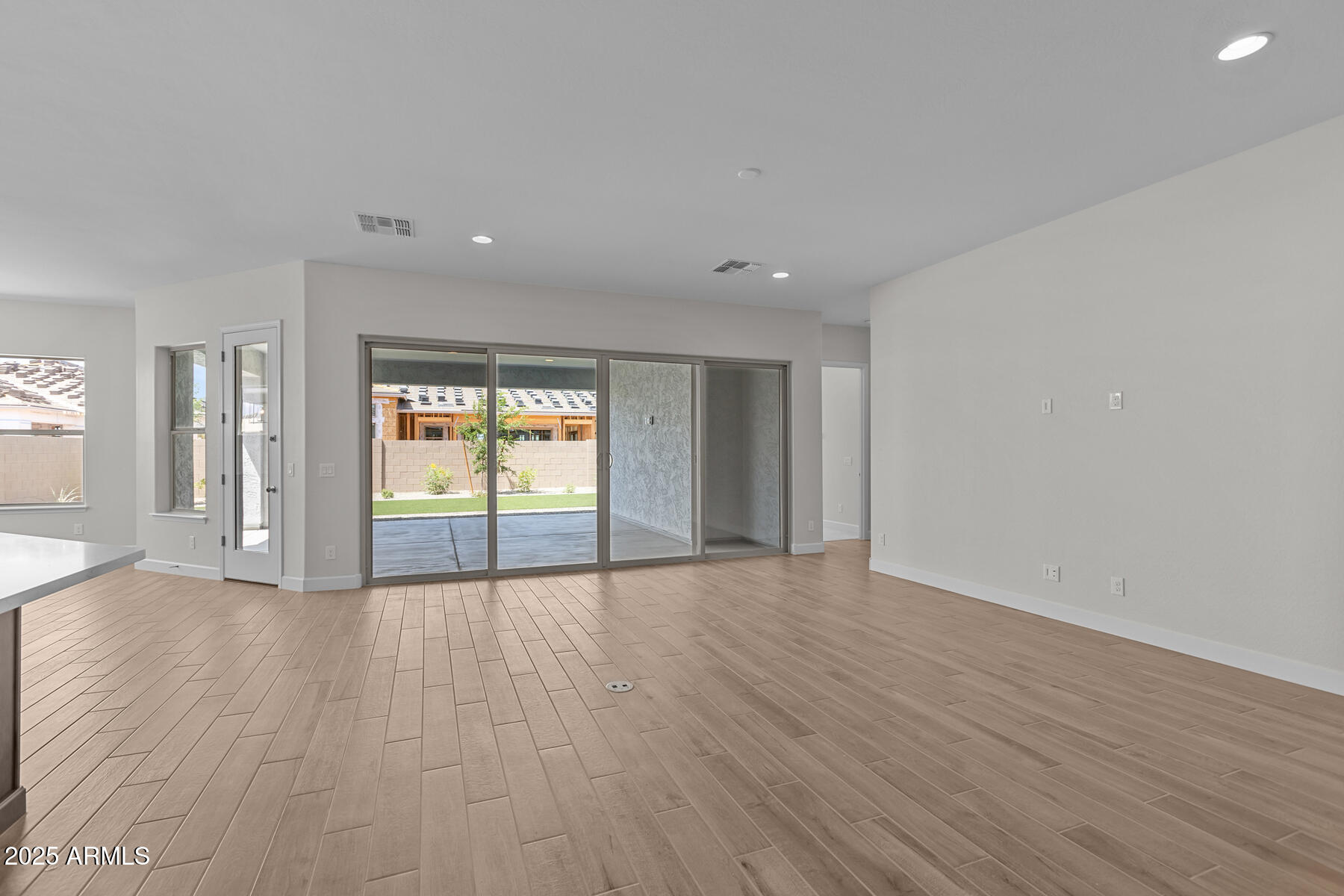 1042 Ridge Road Apache Junction, AZ 85120 - Photo 2 of 27 a view of an empty room with wooden floor and a window