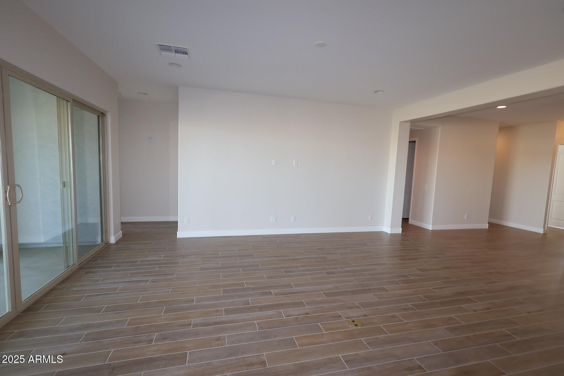 1042 Ridge Road Apache Junction, AZ 85120 - Photo 3 of 27 a view of an empty room with wooden floor and a bathroom