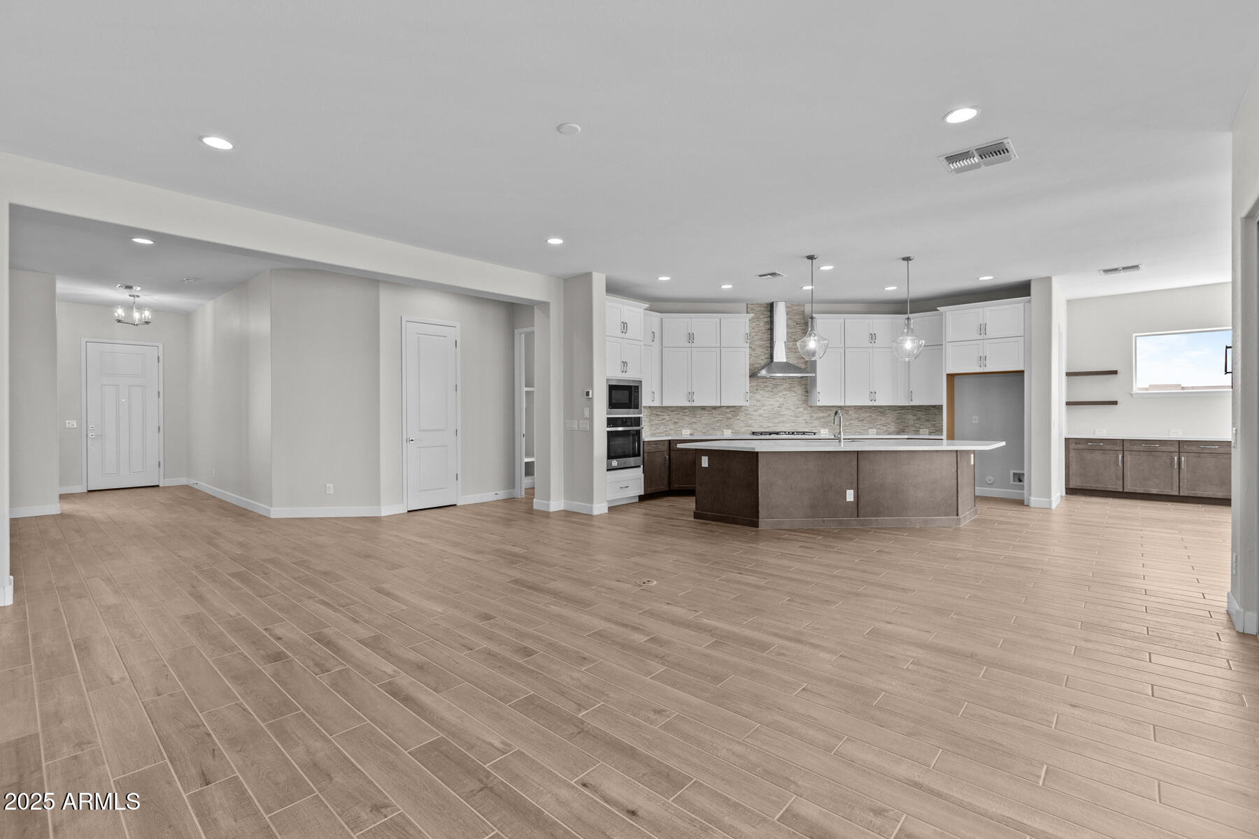 1042 Ridge Road Apache Junction, AZ 85120 - Photo 5 of 27 a large kitchen with stainless steel appliances granite countertop a large counter top and a stove with wooden floor
