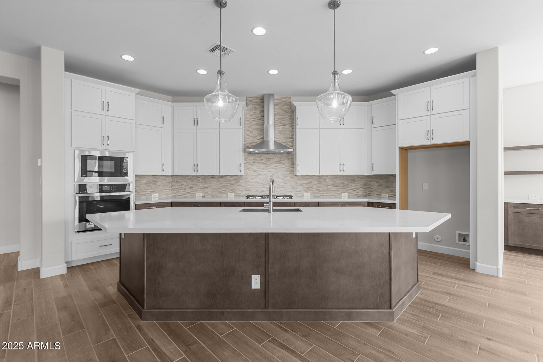1042 Ridge Road Apache Junction, AZ 85120 - Photo 6 of 27 a large kitchen with kitchen island a stove a sink a center island and wooden floor