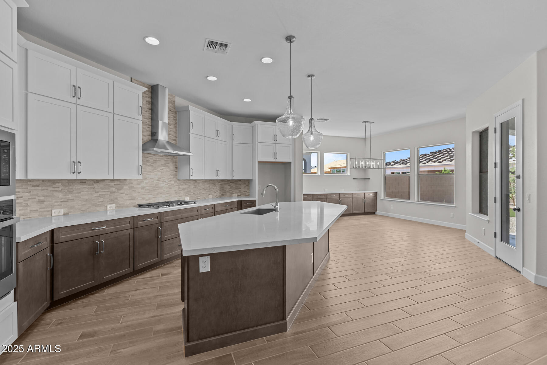 1042 Ridge Road Apache Junction, AZ 85120 - Photo 7 of 27 a large kitchen with stainless steel appliances kitchen island granite countertop a large counter top a stove a sink and a refrigerator
