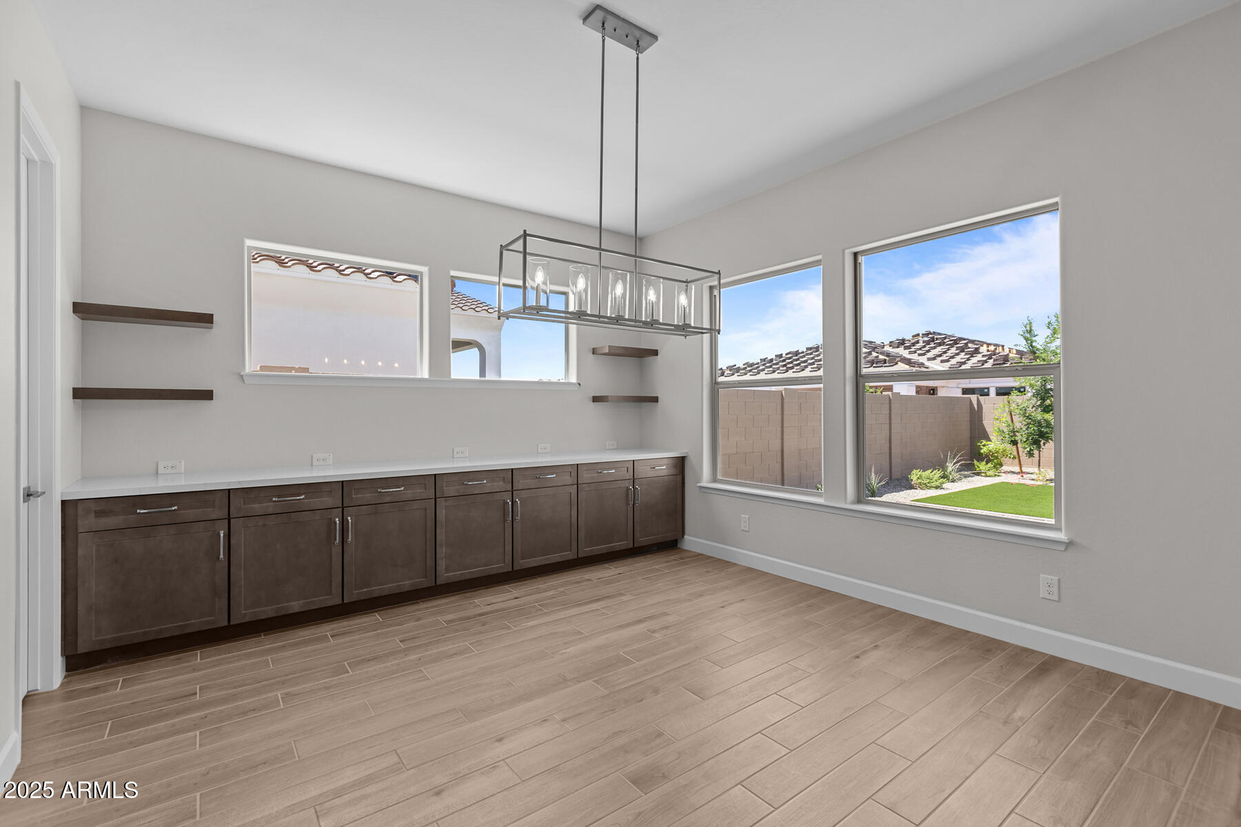 1042 Ridge Road Apache Junction, AZ 85120 - Photo 8 of 27 a view of an empty room with a window and wooden floor