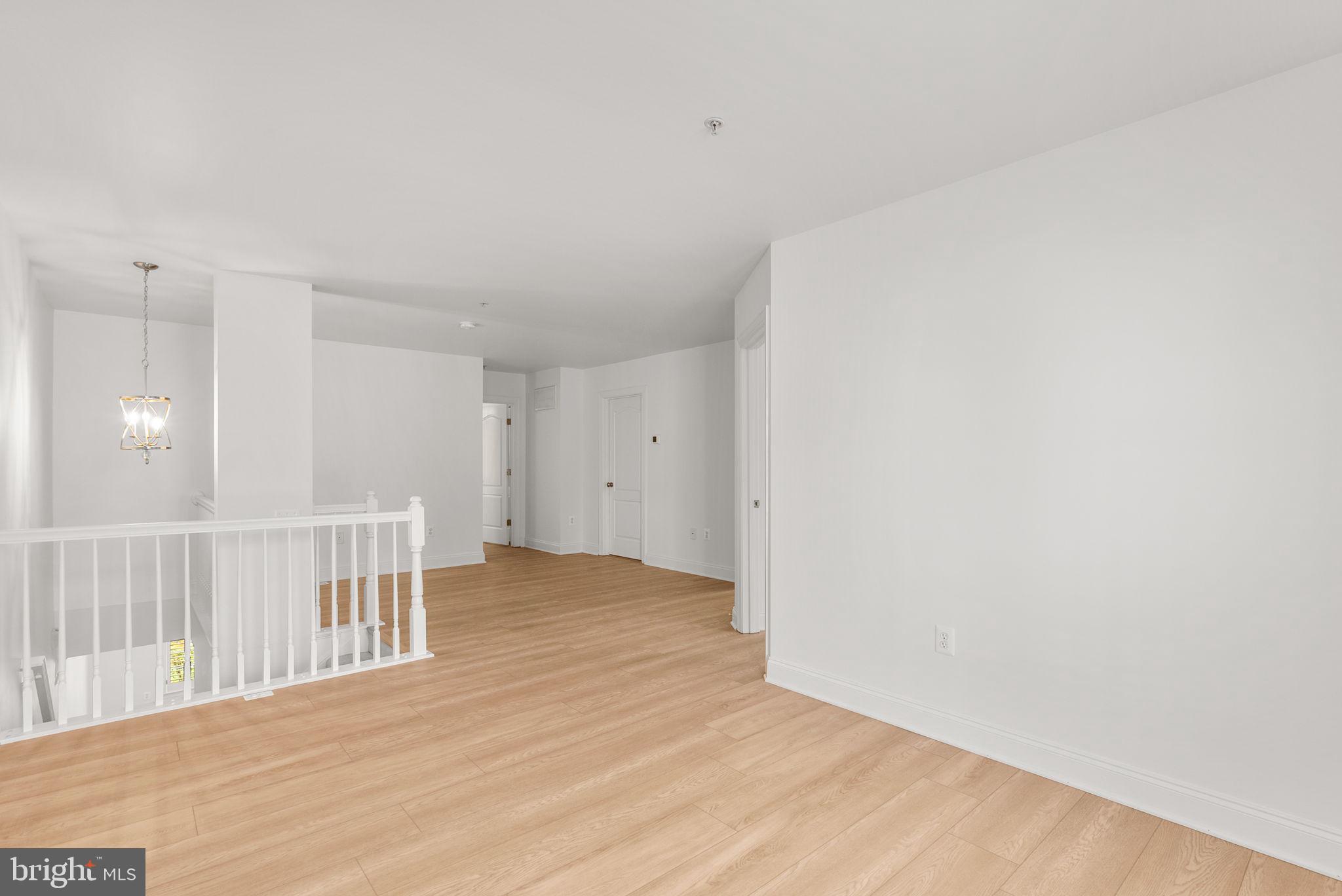 139 Chevy Chase Street, Unit 139 Gaithersburg, MD 20878 - Photo 14 of 27 a view of a livingroom with wooden floor and a bathroom