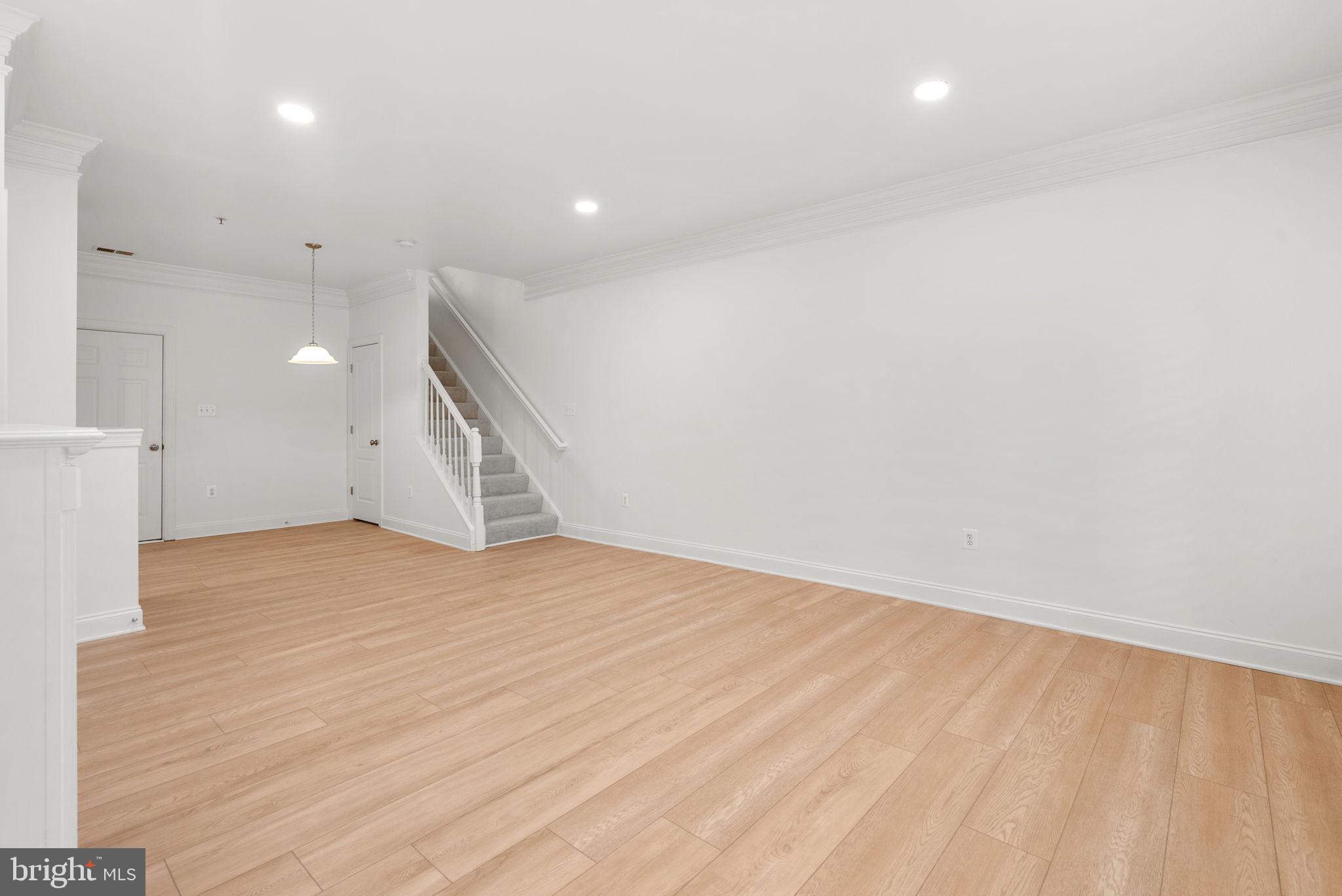139 Chevy Chase Street, Unit 139 Gaithersburg, MD 20878 - Photo 4 of 27 an empty room with wooden floor and windows