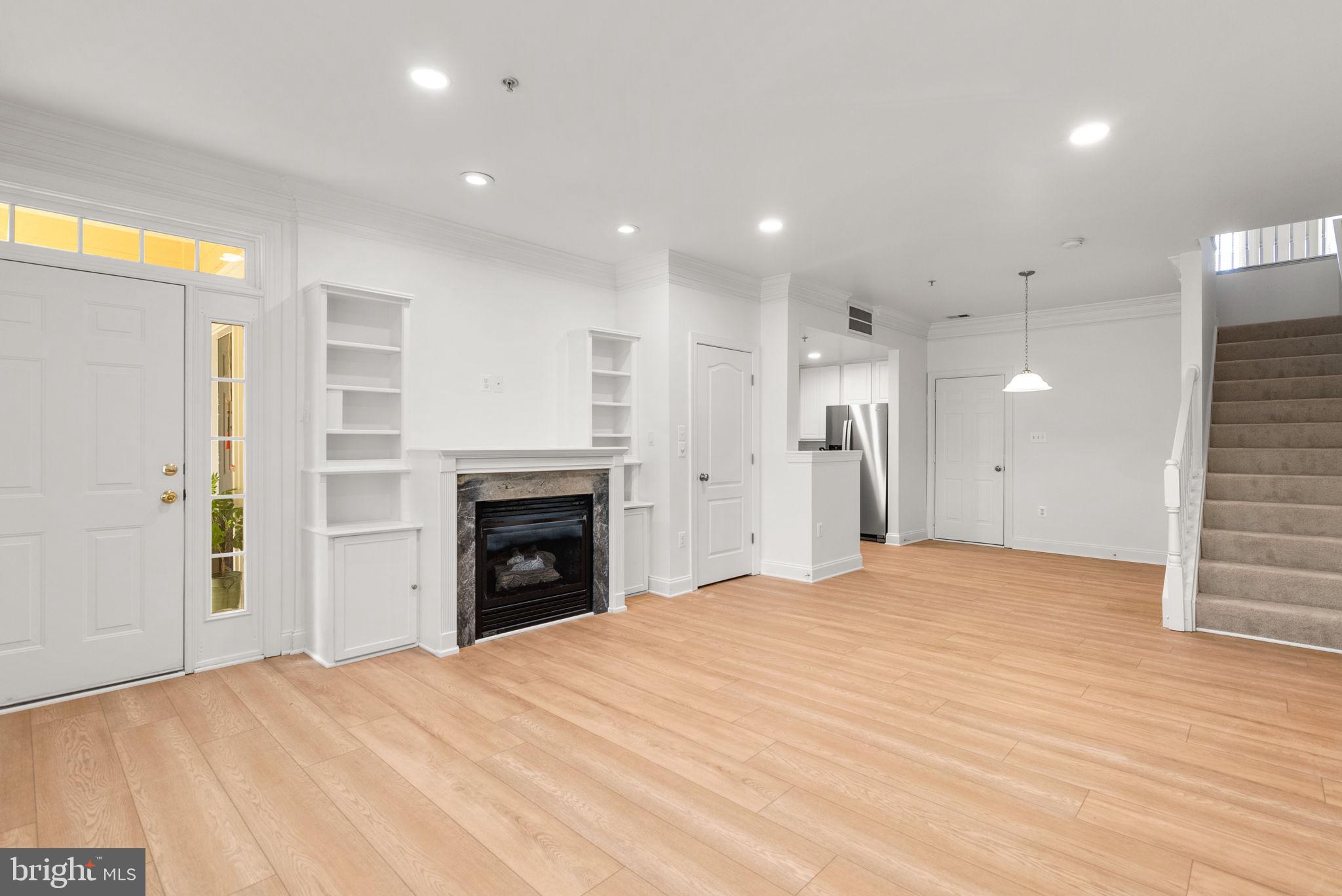 139 Chevy Chase Street, Unit 139 Gaithersburg, MD 20878 - Photo 5 of 27 a view of an empty room with a fireplace and a window