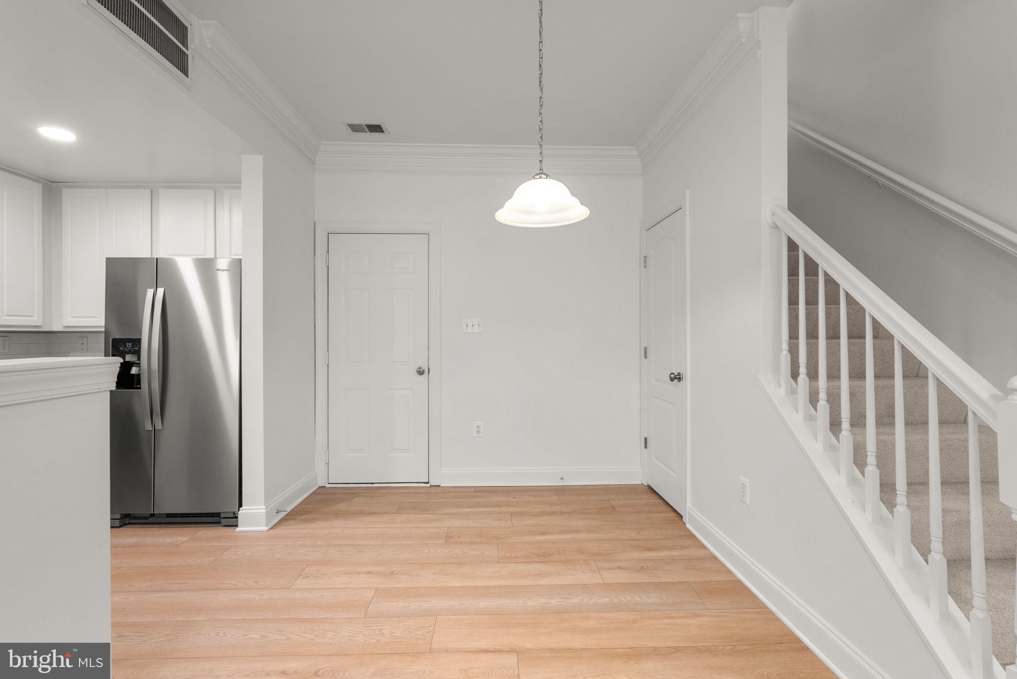 139 Chevy Chase Street, Unit 139 Gaithersburg, MD 20878 - Photo 8 of 27 wooden floor in an empty room with a window
