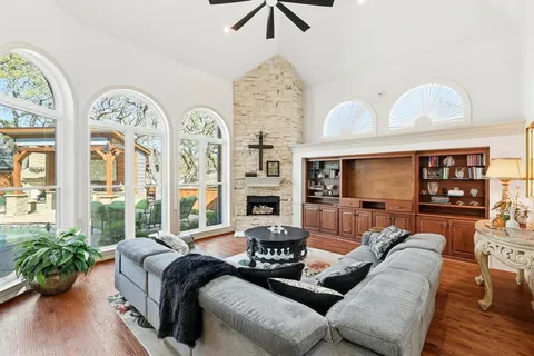 a living room with furniture chandelier and a fireplace