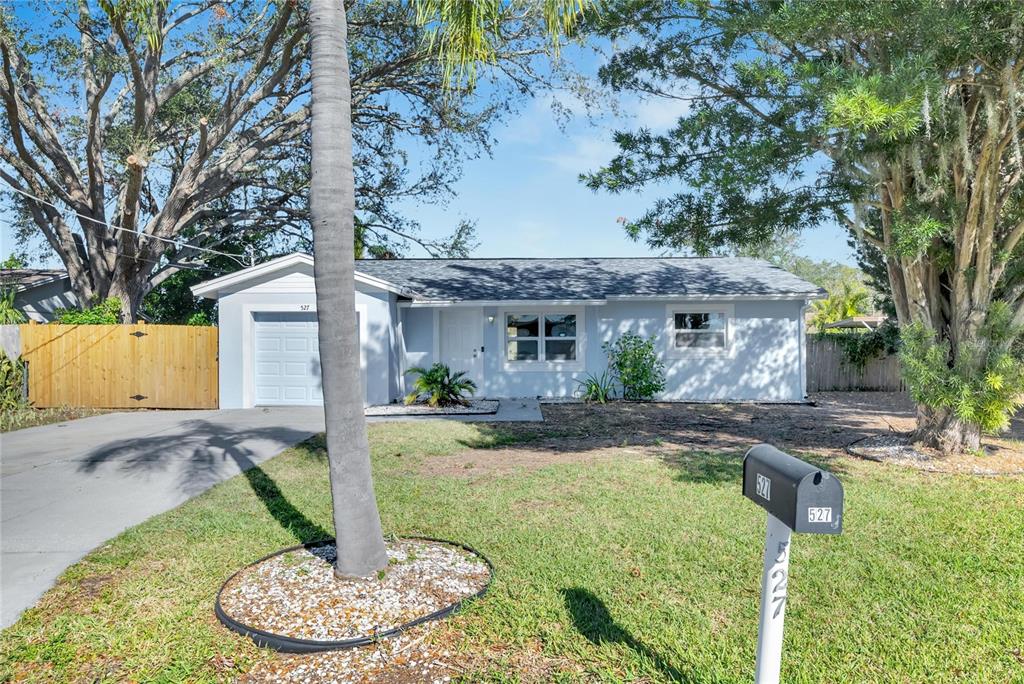 527 Fox Run Trail Apollo Beach, FL 33572 - Photo 1 of 73 a front view of a house with a yard fire pit and outdoor seating