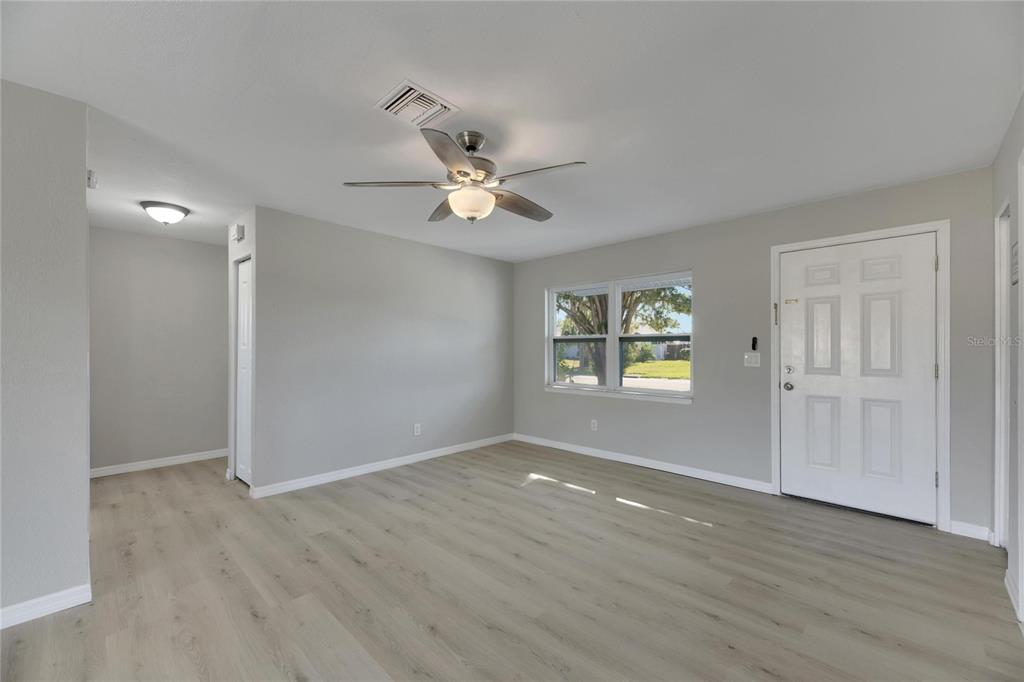 527 Fox Run Trail Apollo Beach, FL 33572 - Photo 16 of 73 an empty room with wooden floor and windows