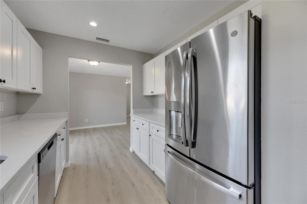 527 Fox Run Trail Apollo Beach, FL 33572 - Photo 26 of 73 a kitchen with stainless steel appliances a refrigerator and a cabinets
