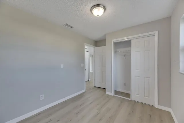 a bathroom with a toilet a sink a window and mirror