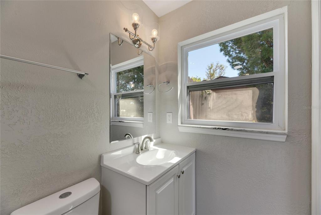 527 Fox Run Trail Apollo Beach, FL 33572 - Photo 40 of 73 a bathroom with a toilet a sink a window and mirror
