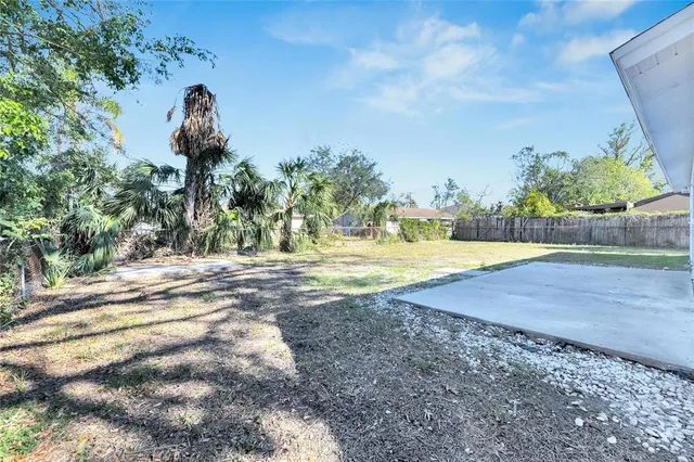 an aerial view of a house with a yard and garden