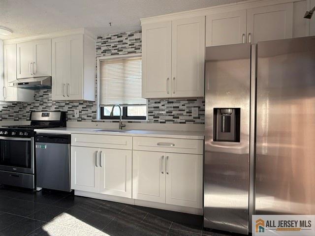 105 Westgate Drive, Unit 105 Edison, NJ 08820 - Photo 11 of 28 a kitchen with stainless steel appliances granite countertop a refrigerator a sink and white cabinets